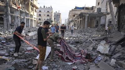Palestinians collect dead from the rubble after the Israeli bombing in Gaza City, October 11, 2023.