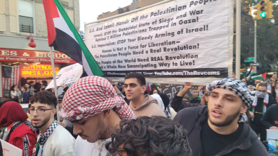 The NYC Revolution Club joined the march through the Bay Ridge section of Brooklyn, with a banner carried by fellow marchers.