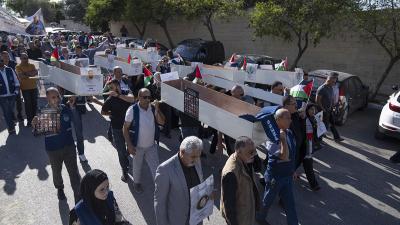 Palestinian journalists carry mock coffins of Palestinian journalists who were killed during the current war in Gaza.