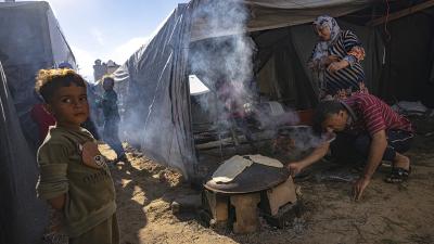 People in tents cooking at a Gaza Strip refugee camp, November 15, 2023.