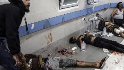 Wounded Palestinians lie on the floor in al-Shifa hospital in Gaza City