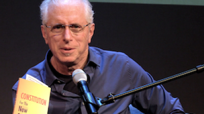 Andy Zee holding Constitution for the New Socialist Republic in North America