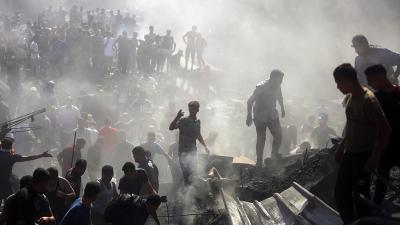 Palestinians search through rubble in Khan Younis after Israeli airstrikes, October 26, 2023.