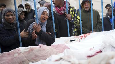 Palestinians at a hospital in Deir al Balah,l Gaza Strip, mourn the relatives killed in the Israeli air and ground offensive, January 26, 2024.