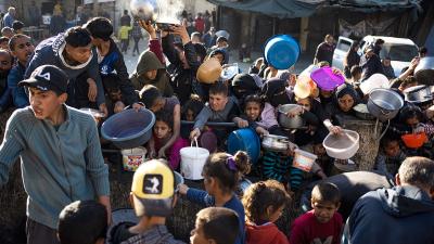 Thousands of Palestinians wait for food trucks in Rafah, March 12, 2024.