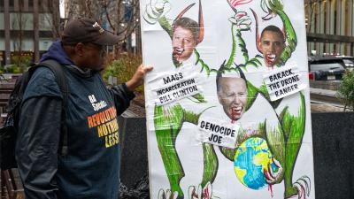 New York City, Radio City protest: poster of Genocide Joe, Barack the Drone Ranger, and Mass Incarceration Bill Clinton, March 28, 2024.