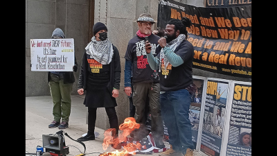 The Revcom Corps for the Emancipation of Humanity in Chicago, including one person who is a Vietnam-era veteran, burned an American flag in front of City Hall, April 1, 2024.