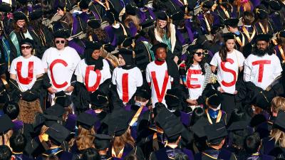  UC Berkeley Law School graduates wear T-shirts that read "UC DIVEST" during commencement, May 10, 2024.