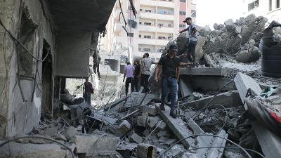 Palestinians search rubble from the Israeli bombing in Nuseirat refugee camp, Gaza Strip, June 8, 2024.