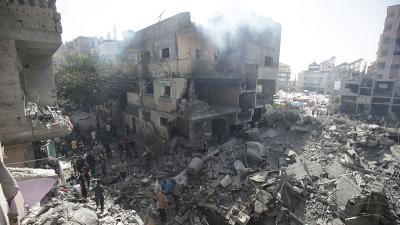 Palestinians look at the rubble from the Israeli bombing in Nuseirat refugee camp, Gaza Strip, June 8, 2024
