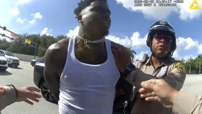 This body cam image from Miami-Dade Police shows Miami Dolphins receiver Tyreek Hill being arrested during a traffic stop, September 8, 2024. 