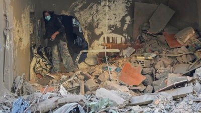 Woman searches for her belongings after Israeli airstrike on Beirut, Lebanon, October 11, 2024.