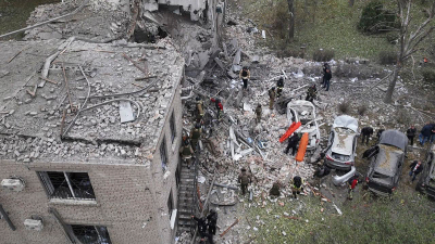 Workers clear the rubble after an overnight Russian attack with guided bombs in Zaporizhzhia, Ukraine, October 21, 2024.