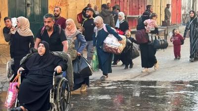 Palestinian refugees traveling on the streets of Gaza fleeing Israeli attacks.