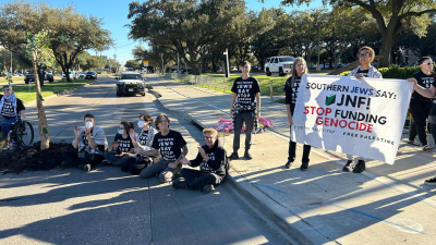Protesters blocked the street and planted a symbolic olive tree to stop the genocidal Jewish National Fund “Conference for Israel” in Dallas, November 14, 2024.