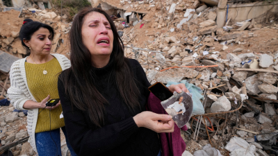 Lebanese woman with a photo of her father, found in the rubble of her destroyed house in Baalbek, eastern Lebanon, November 28, 2024.