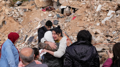 Grieving in front of their destroyed house in Baalbek, eastern Lebanon, November 28, 2024