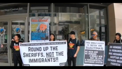 Revcoms protest the San Diego County Sheriff, who said her office won’t comply with the city’s new sanctuary policy.