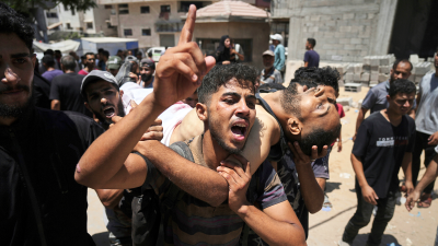 Palestinians wounded and killed while trying to reach aid trucks are brought to Shifa Hospital in Gaza City, July 20, 2025.
