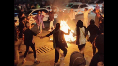 Women dance around a bonfire of burning headscarves, Bandar Abbas, Iran, September 22, 2022.