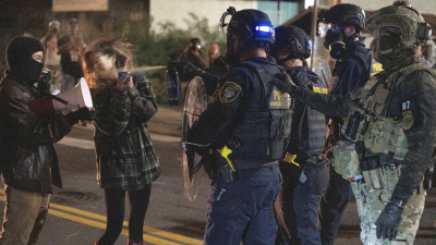 A protester is sprayed by a Department of Homeland Security officer outside the Portland ICE facility, October 2, 2025.