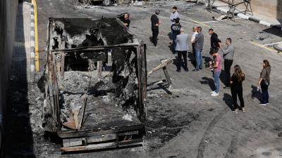 Palestinians survey damage from Israeli settlers attack on an industrial zone in West Bank village near Tulkarm, November 12, 2025.
