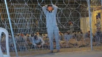 Blindfolded Palestinian prisoners at Sde Tieman prison, winter 2023.