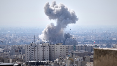 A plume of smoke rises after a strike in Tehran, Iran, March 1, 2026.