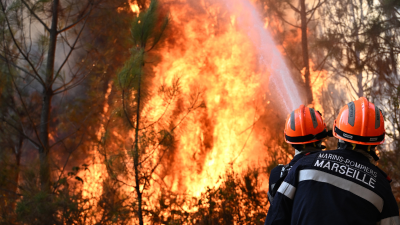 Firefighters work to extinguish a fire near Blagon, southwestern France, July 29, 2026.
