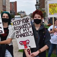 Women holding signs at Landsing pro-choice rally