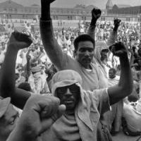 Attica prisoners with fists in the air.