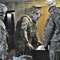 U.S. embassy delegation led by Army military attaché reviews map with Ukrainian officers who are conducting military operations against pro-Russian forces in eastern Ukraine.