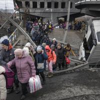 Ukrainians walk path after Russian airstrike destroyed bridge.