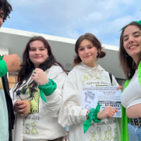 Young people with green bandanas