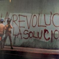 After beating of Rodney King, graffiti on wall in LA: Revolución La Solución.