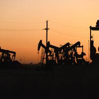 Texas oil pumpjacks operating at the site of a new oil and gas well, April 2022.