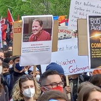 Marchers with posters of Bob Avakian and The New Communism