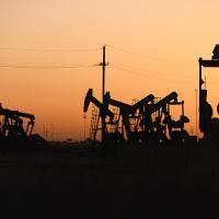 Texas oil pumpjacks operating at the site of a new oil and gas well, April 2022.