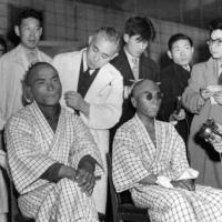 Two Japanese fishermen, among 23 showered with radioactive ash from the thermonuclear explosion at Bikini on March 1, 1954, show burns they suffered.