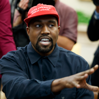 Kanye West wearing a MAGA hat.