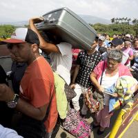 Venezuelan refugees wait to cross the border into Colombia.