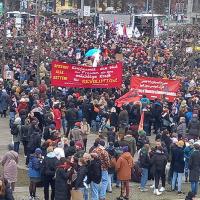 Berlin, IWD 2023, revolutionary banners held high in crowd