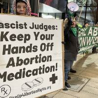 Woman with sign: Fascist Judges Keep Your Hands Off Abortion Medication
