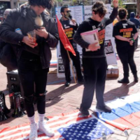 Standing on the American and Russian flags at the April 2 protests.