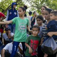 Migrant asylum seekers on the Mexican side of the Rio Grande river bank waiting to cross to the U.S. before Title 42 ends, May 10, 2023.