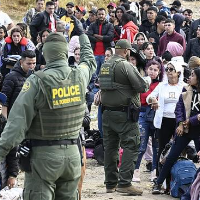 Border patrol hands out bracelets to asylum seekers waiting to cross to U.S. near Tijuana, Mexico, Monday, May 8, 2023.