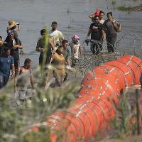 Migrants from Mexico stopped from crossing the Rio Grande by barbed wired buoys
