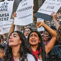 Women protesting "Say her name, Mahsa Amini" and "Women Life Freedom"