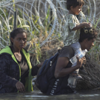 Immigrants in river, barbed wire