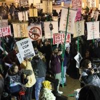 Large, diverse crowd of protesters with "Stop Cop City" signs